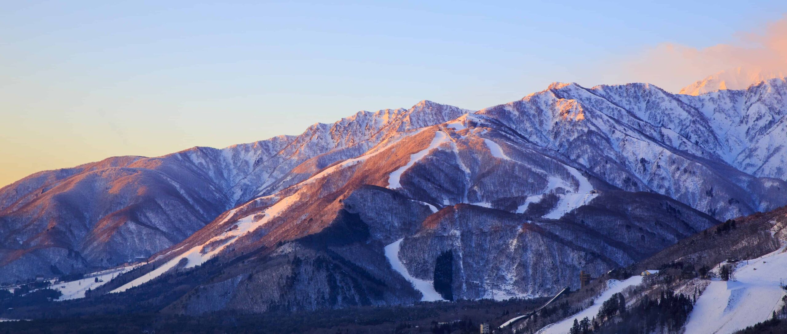 Snow-covered mountains and ski slopes in Hakuba, Japan